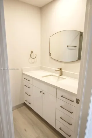 a bathroom with a sink and mirror