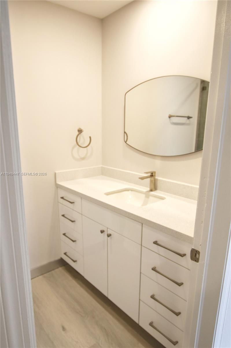 10681 Southwest 156th Place, Unit 402 Miami, FL 33196 - Photo 15 of 36 a bathroom with a sink and mirror