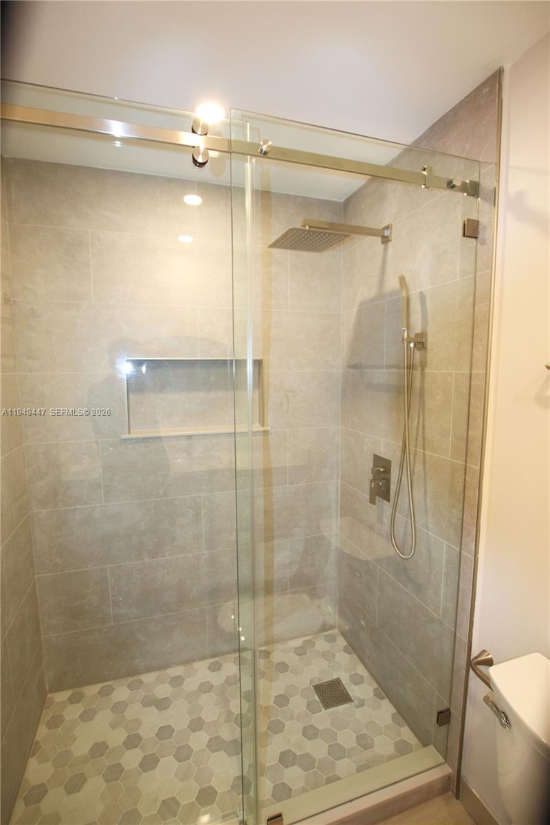 10681 Southwest 156th Place, Unit 402 Miami, FL 33196 - Photo 16 of 36 a bathroom with a shower and a toilet