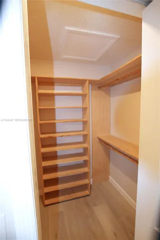 a view of walk in closet with empty racks