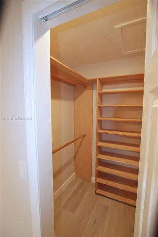 a view of walk in closet with empty racks