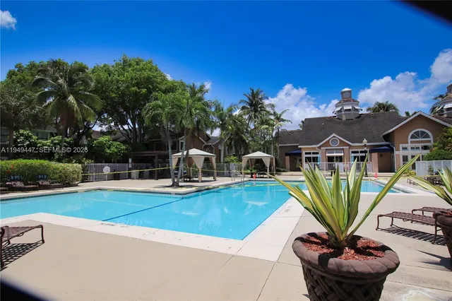 a view of a swimming pool with a table and chairs