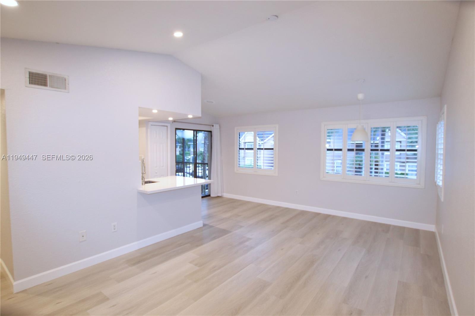10681 Southwest 156th Place, Unit 402 Miami, FL 33196 - Photo 4 of 36 wooden floor in an empty room with a window