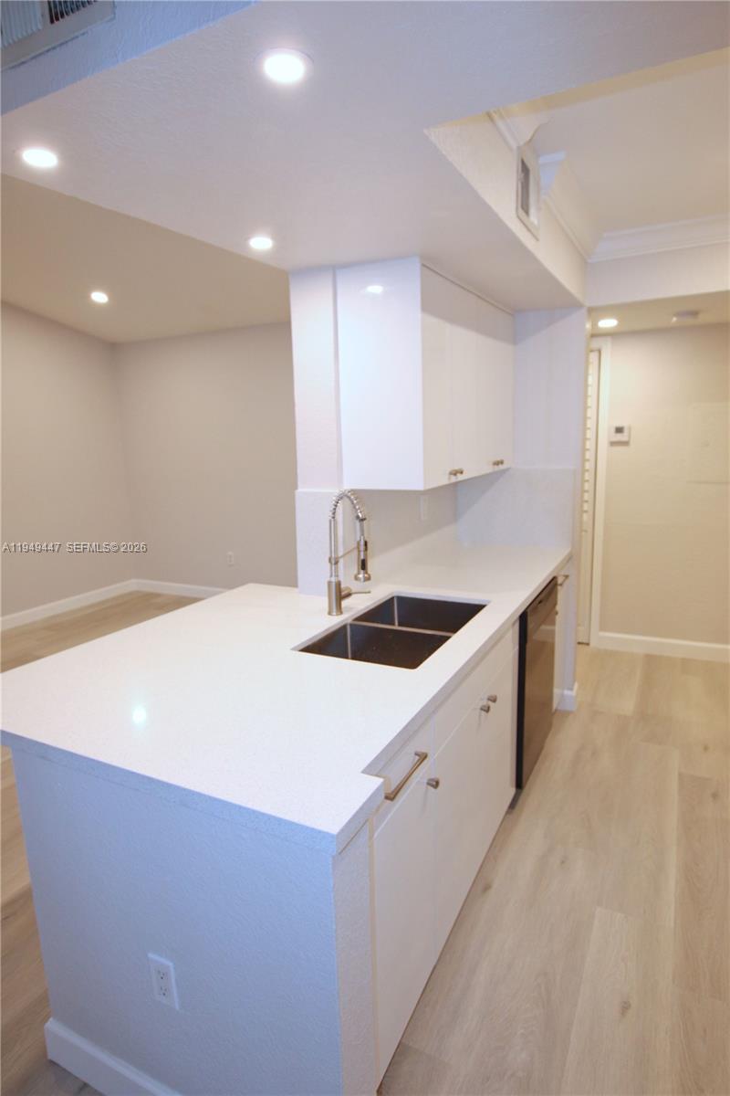 10681 Southwest 156th Place, Unit 402 Miami, FL 33196 - Photo 7 of 36 a kitchen with kitchen island sink stove and refrigerator