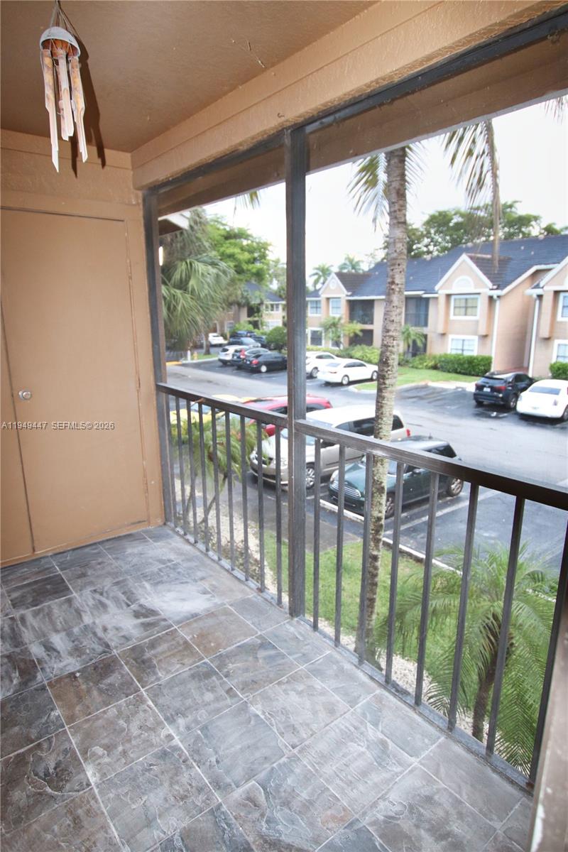 10681 Southwest 156th Place, Unit 402 Miami, FL 33196 - Photo 9 of 36 a view of a porch with a big yard