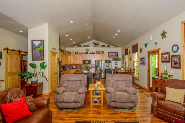 a living room with furniture and a chandelier