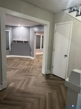 a view of a hallway with wooden floor