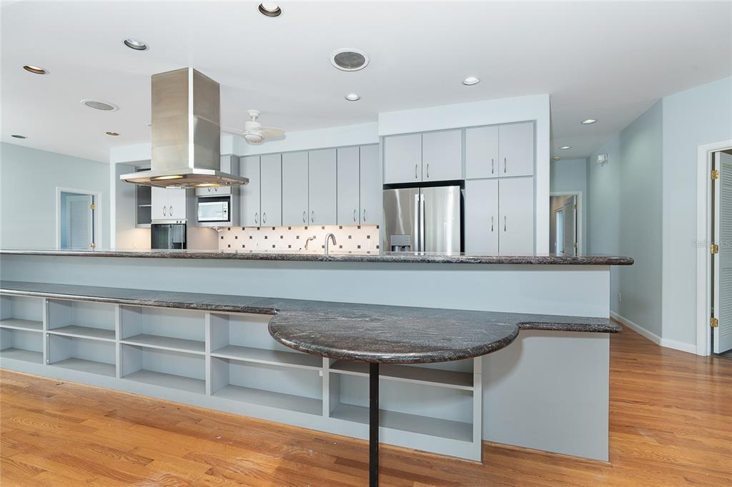 5 Pointe Way Placida, FL 33946 - Photo 17 of 69 a kitchen with kitchen island granite countertop a stove and a wooden floors