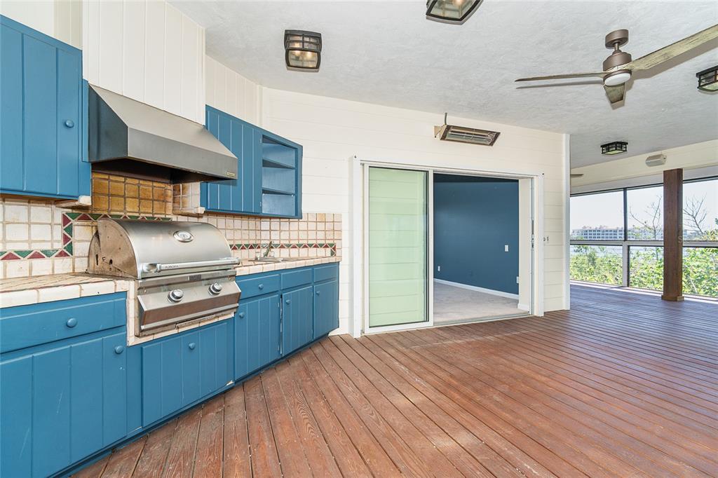 5 Pointe Way Placida, FL 33946 - Photo 24 of 69 a kitchen with stainless steel appliances granite countertop a sink and wooden cabinets with a large window