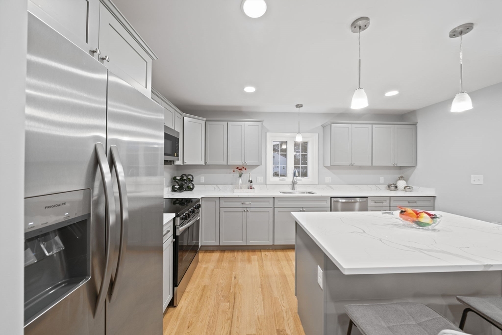 20 Simmonds Boulevard, Unit 20 Randolph, MA 02368 - Photo 7 of 29 a kitchen with a sink stainless steel appliances and cabinets