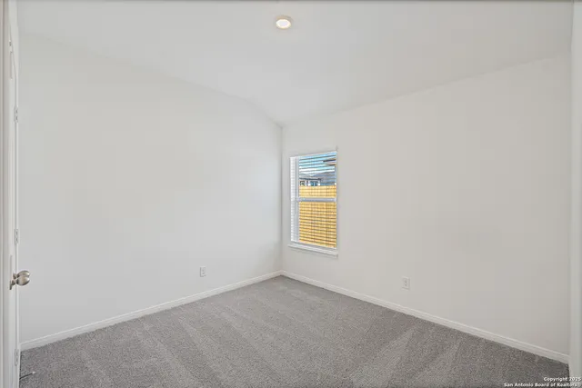 a view of an empty room and a window