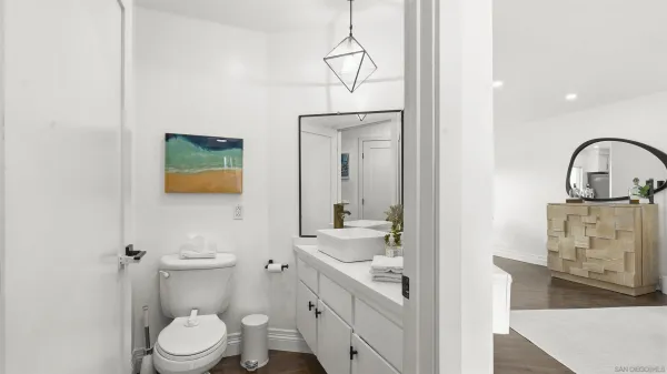 a bathroom with a toilet a sink and mirror