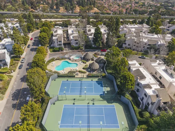 an aerial view of a house with a yard basket ball court
