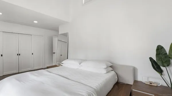a bedroom with a bed and chair