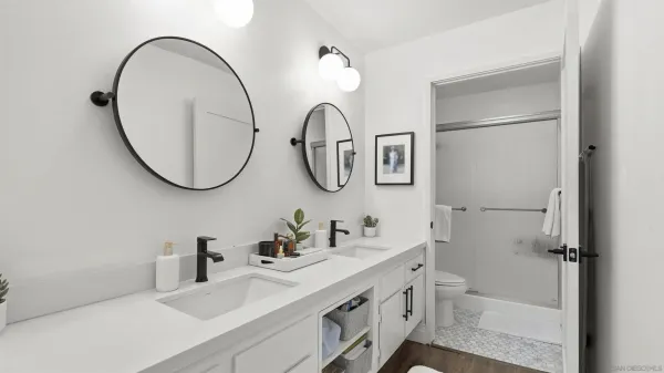 a bathroom with a sink a toilet and a mirror