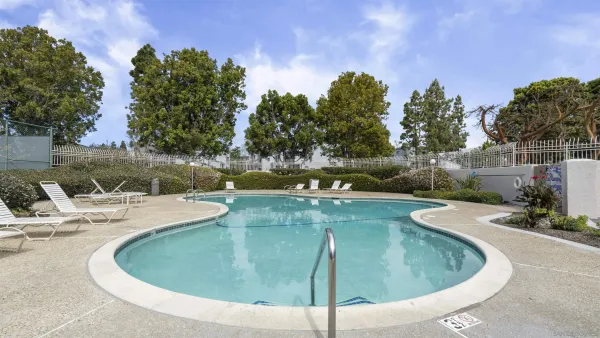 a view of a swimming pool with sitting area