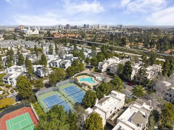 an aerial view of residential houses with city view