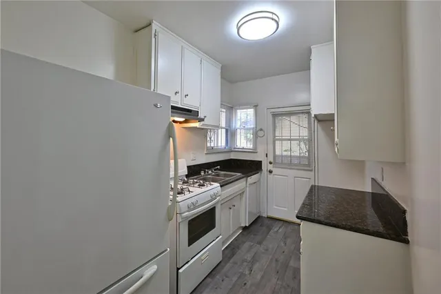 a kitchen with a stove and a refrigerator