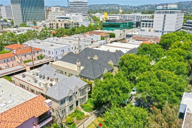 an aerial view of a residential apartment building with a yard and lake view