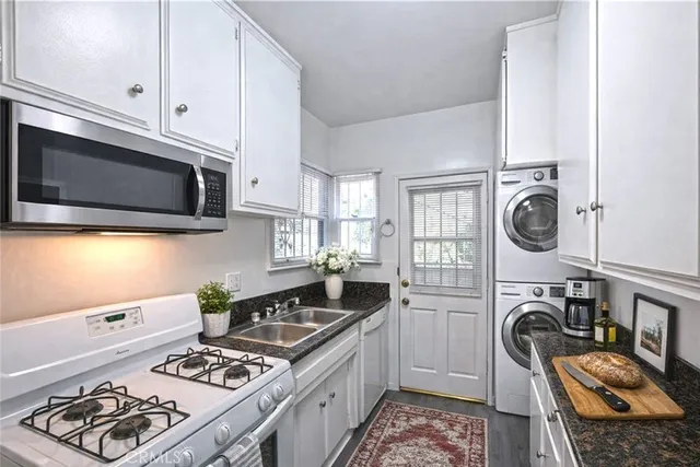 a kitchen with stainless steel appliances granite countertop a stove and a microwave