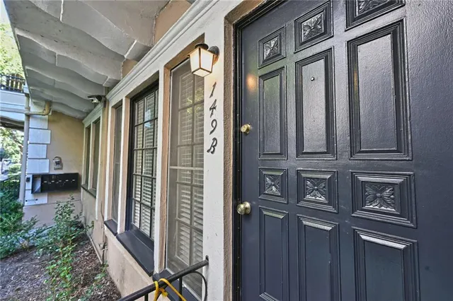 a view of a brick house with a door and chair