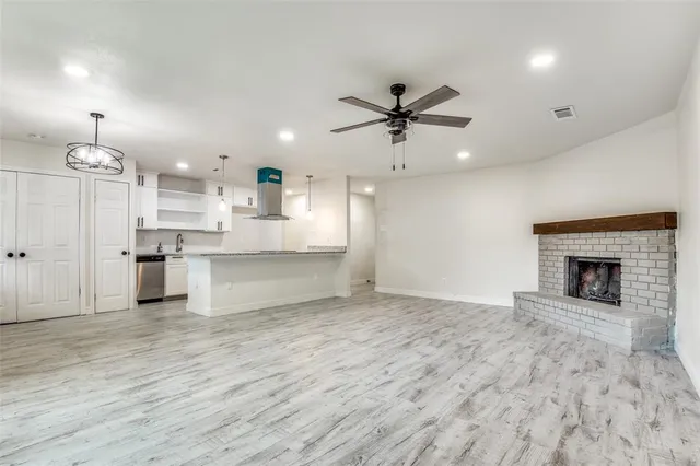 a view of a kitchen with a sink and a fireplace