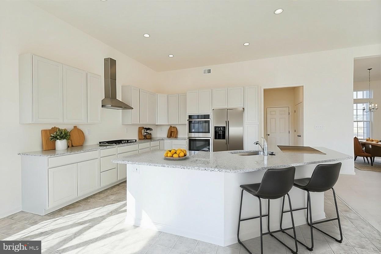 910 Weatherstone Lane Felton, DE 19943 - Photo 11 of 29 a kitchen with stainless steel appliances a sink a stove a refrigerator cabinets and chairs