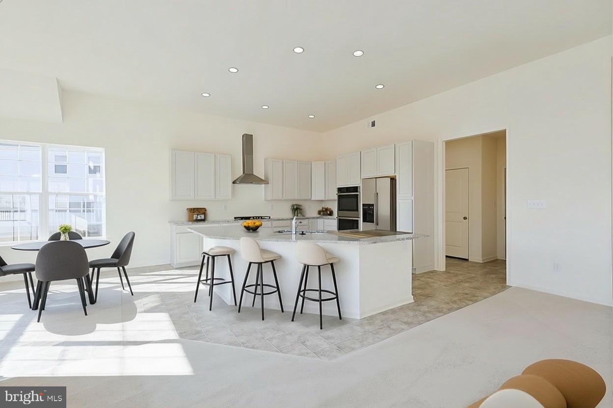 910 Weatherstone Lane Felton, DE 19943 - Photo 12 of 29 a living room with stainless steel appliances kitchen island granite countertop furniture and a couch