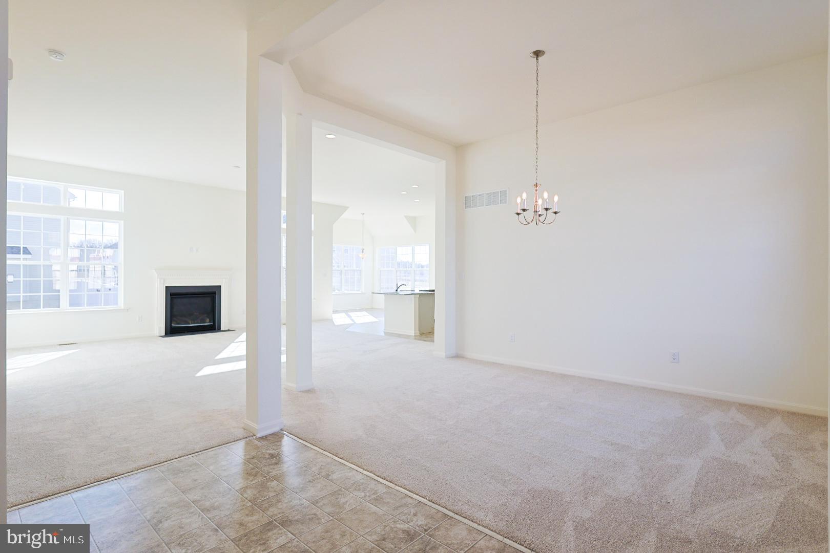 910 Weatherstone Lane Felton, DE 19943 - Photo 2 of 29 a view of a hallway with wooden floor and a bathroom