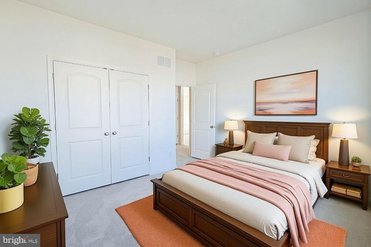 910 Weatherstone Lane Felton, DE 19943 - Photo 29 of 29 a bedroom with bed and a potted plant