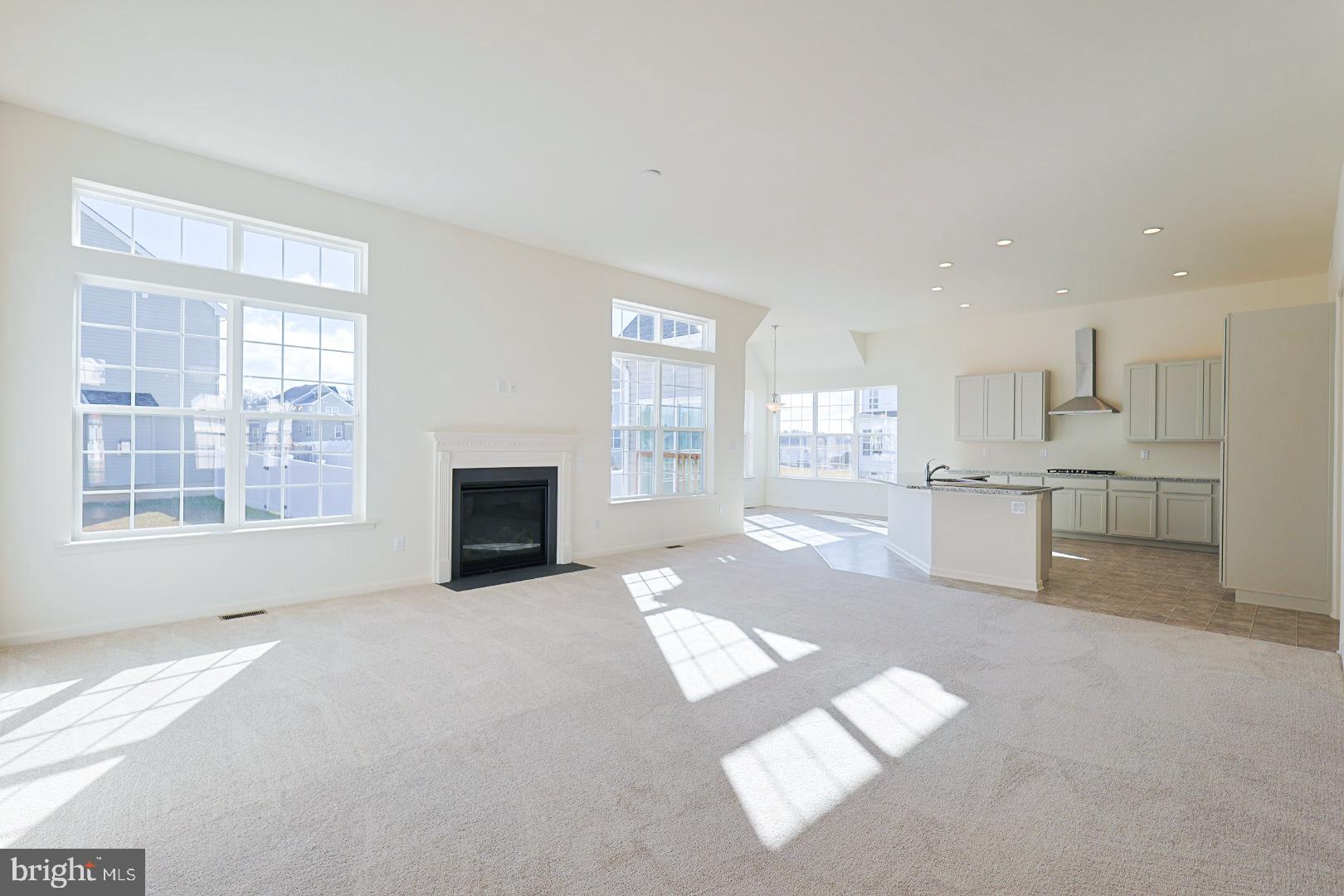 910 Weatherstone Lane Felton, DE 19943 - Photo 5 of 29 a view of an empty room with window and kitchen view