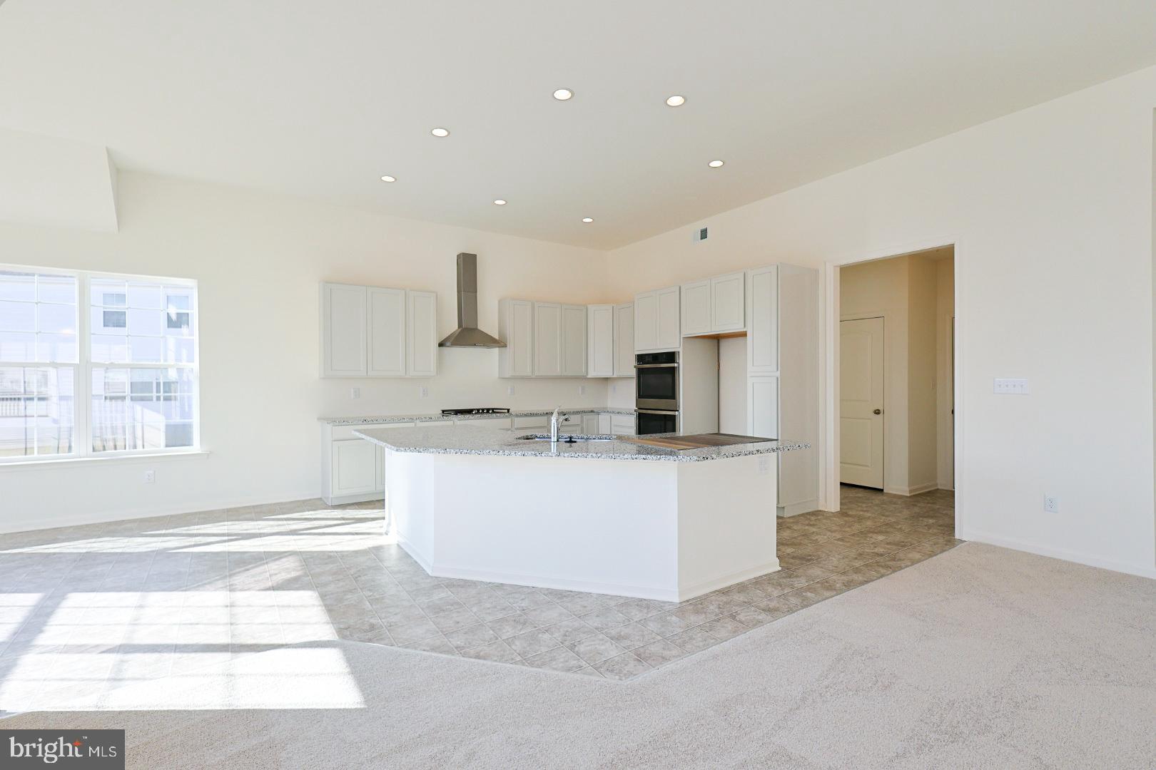 910 Weatherstone Lane Felton, DE 19943 - Photo 8 of 29 a living room with kitchen island furniture and a window