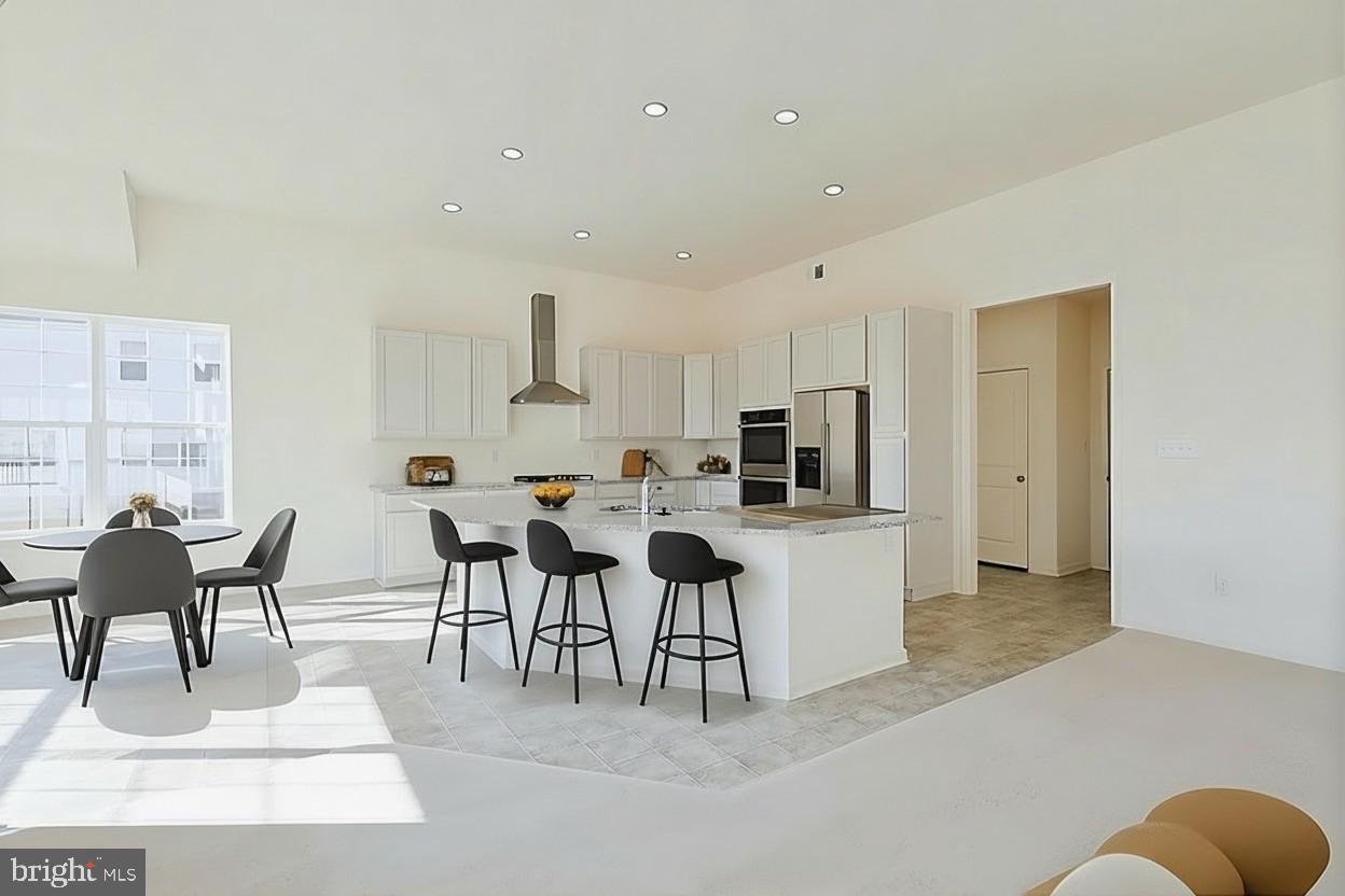 910 Weatherstone Lane Felton, DE 19943 - Photo 9 of 29 a living room with stainless steel appliances kitchen island granite countertop furniture and a couch