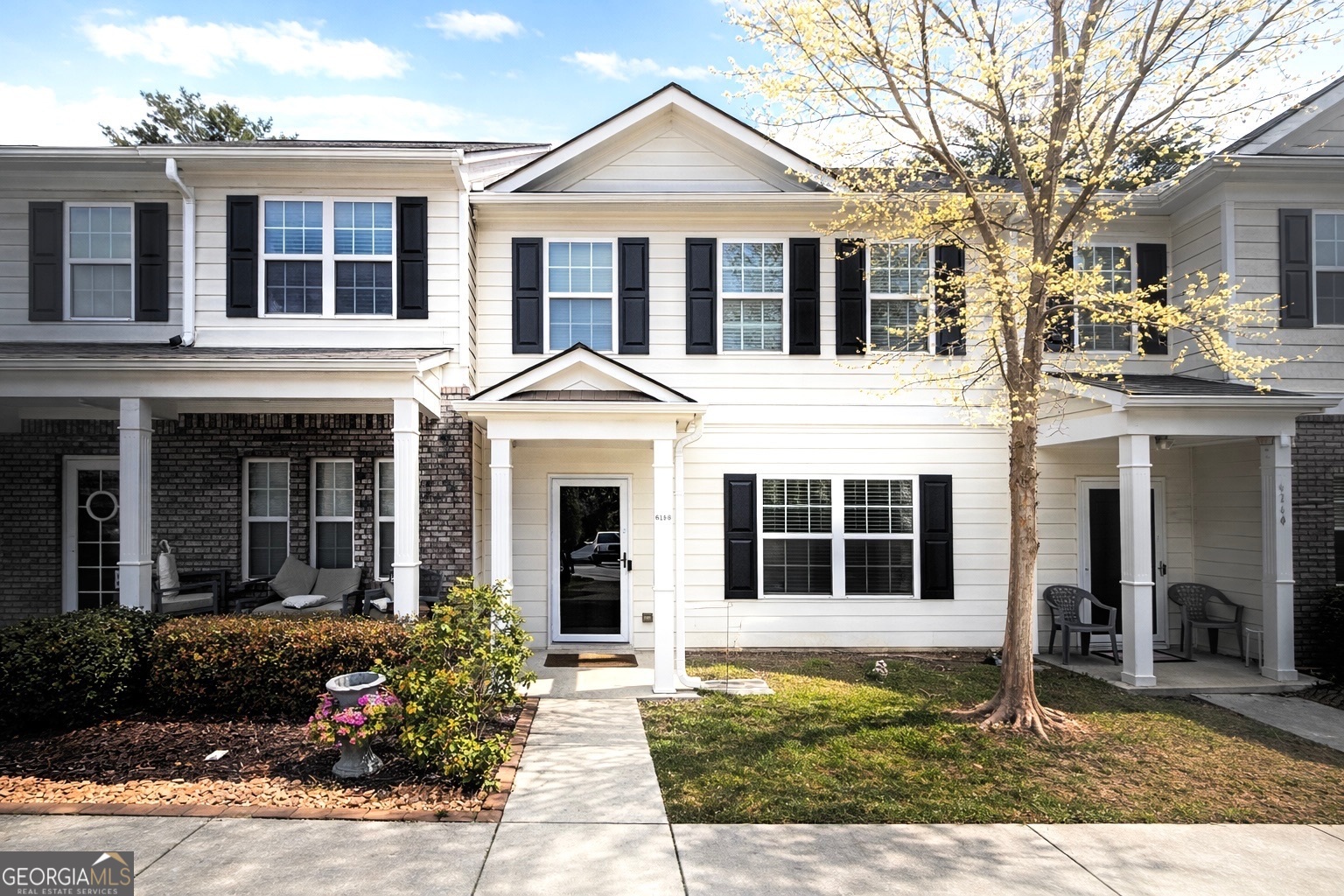 a view of a white house with large windows and a large windows