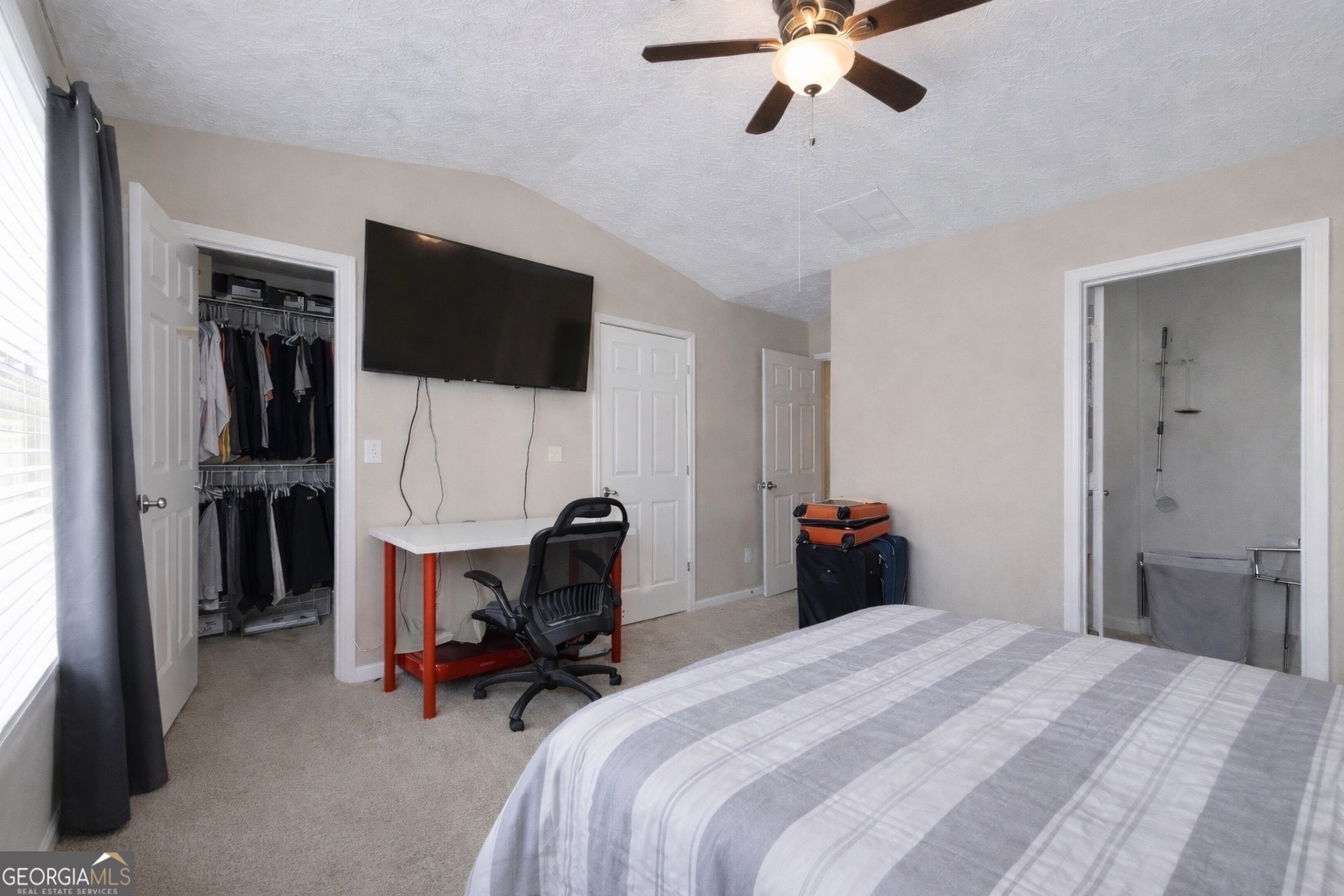 6198 Shoals Loop Union City, GA 30291 - Photo 14 of 21 a bedroom with a bed and a chandelier