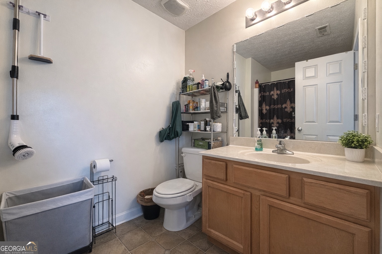 6198 Shoals Loop Union City, GA 30291 - Photo 16 of 21 a bathroom with a toilet sink and mirror