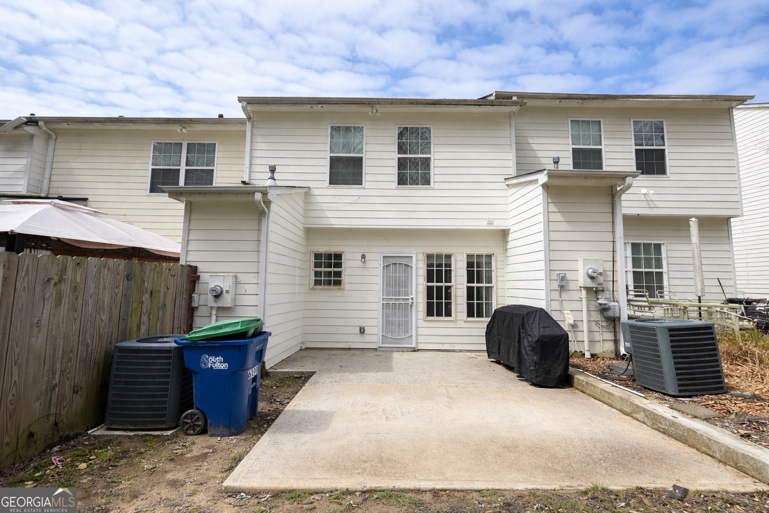 6198 Shoals Loop Union City, GA 30291 - Photo 21 of 21 a view of a house with a barbeque and wooden fence