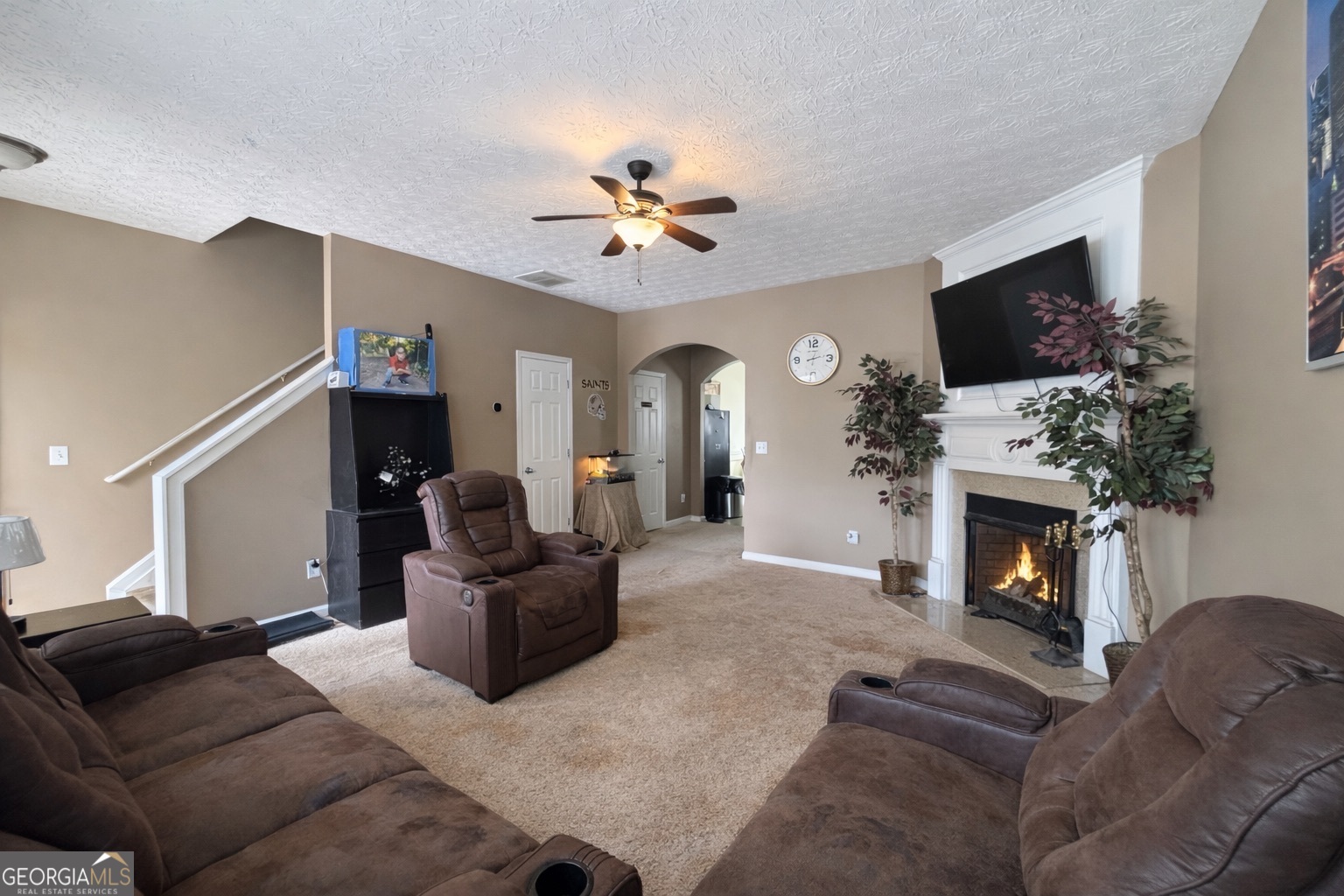 6198 Shoals Loop Union City, GA 30291 - Photo 3 of 21 a living room with furniture a flat screen tv and a fireplace