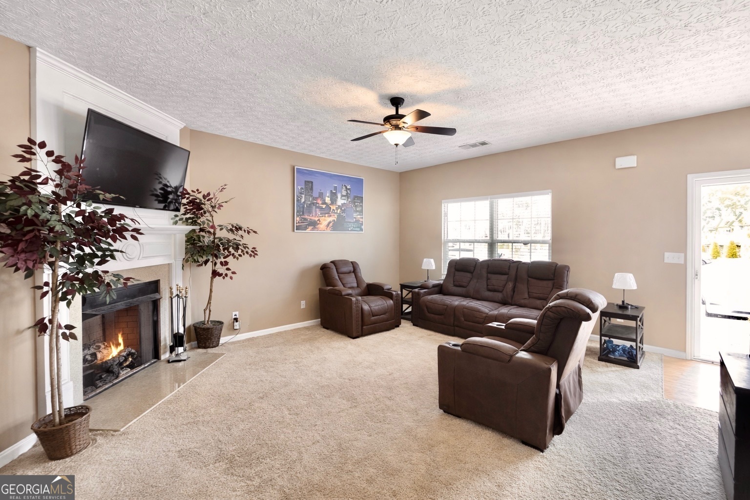6198 Shoals Loop Union City, GA 30291 - Photo 5 of 21 a living room with furniture a fireplace and a flat screen tv