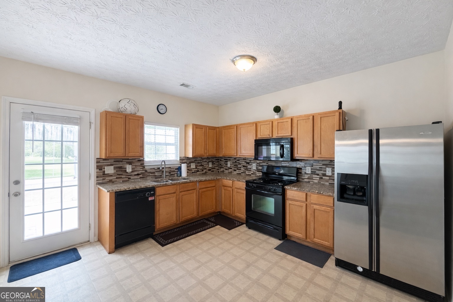 6198 Shoals Loop Union City, GA 30291 - Photo 7 of 21 a kitchen with stainless steel appliances granite countertop a stove a refrigerator and a stove