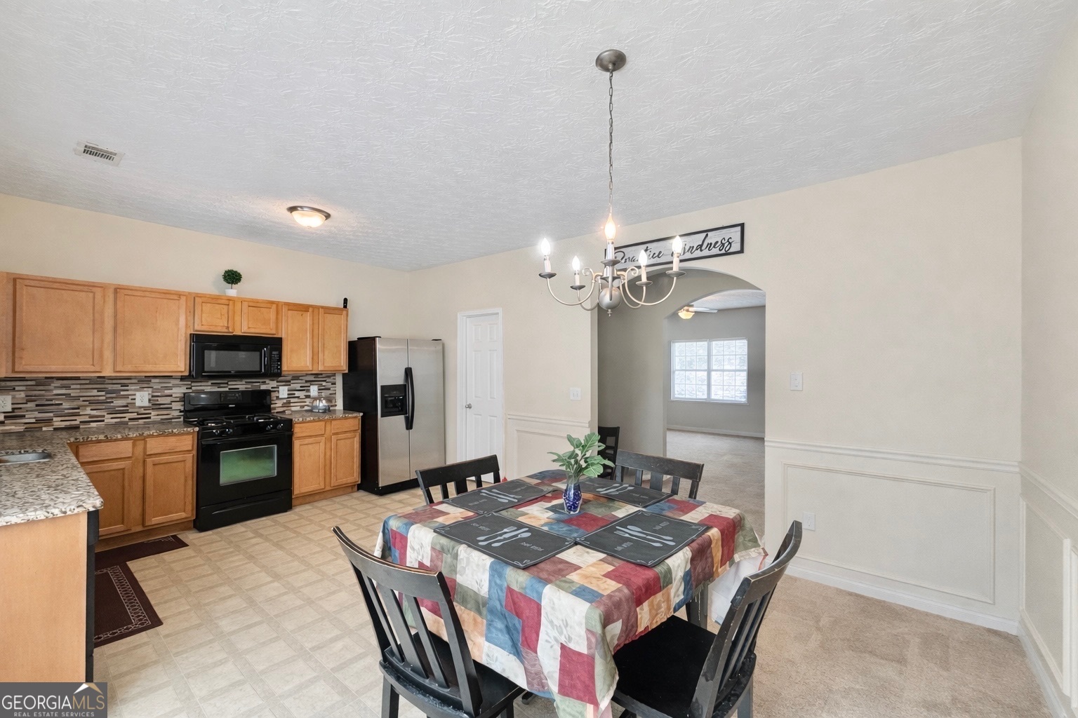 6198 Shoals Loop Union City, GA 30291 - Photo 8 of 21 a view of a dining room and livingroom with furniture wooden floor a chandelier