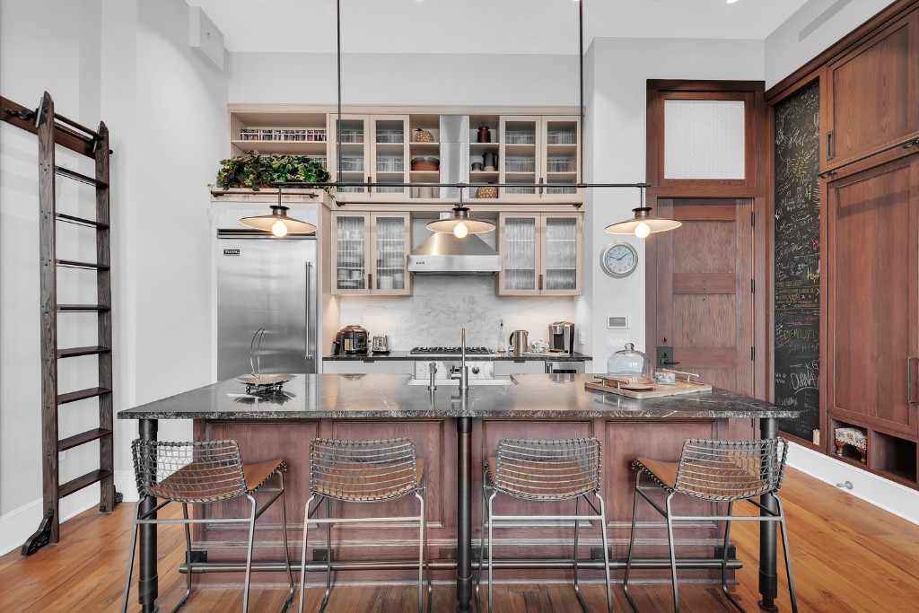 an open kitchen with granite countertop a stove a sink and a refrigerator
