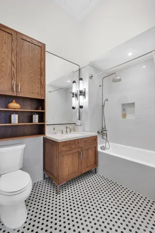 a bathroom with a sink a toilet and bathtub