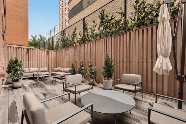 a view of backyard with a patio and outdoor seating