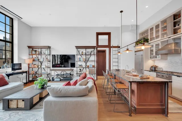 a living room with furniture a flat screen tv and a large window