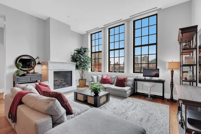 a living room with furniture and a fireplace