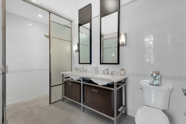 a bathroom with a toilet sink and mirror