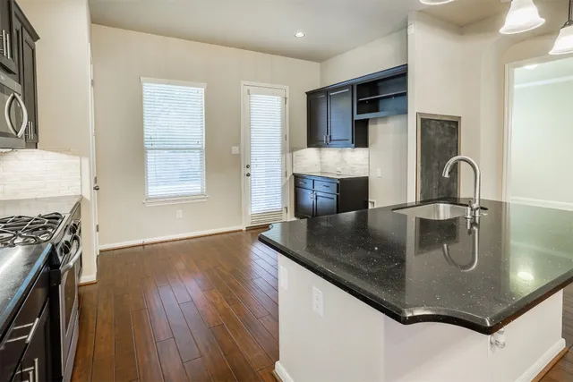 a kitchen with a sink a stove and oven