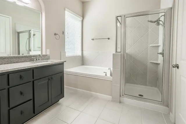 a bathroom with a granite countertop sink a toilet and shower