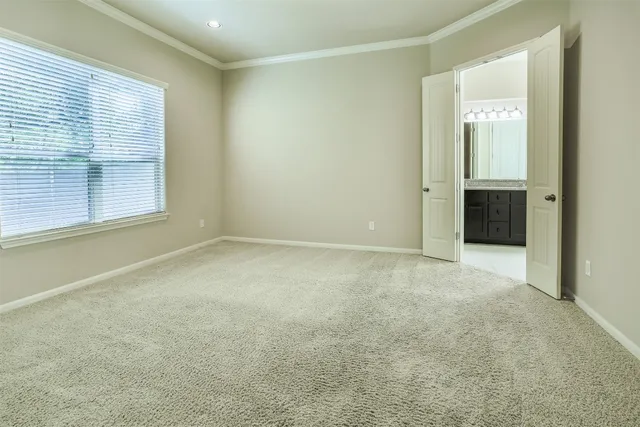 an empty room with windows and closet